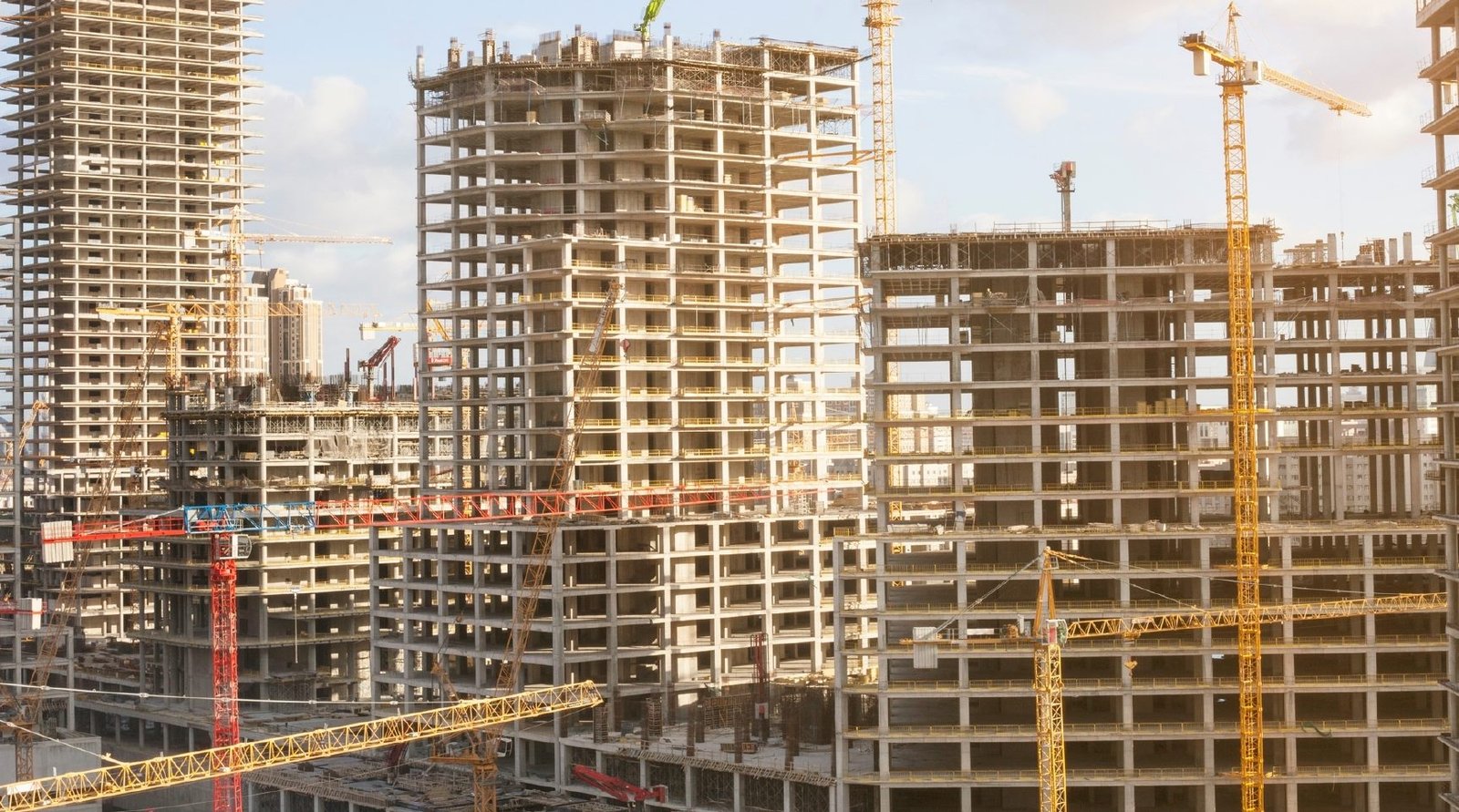 High-rise building construction with multiple tower cranes