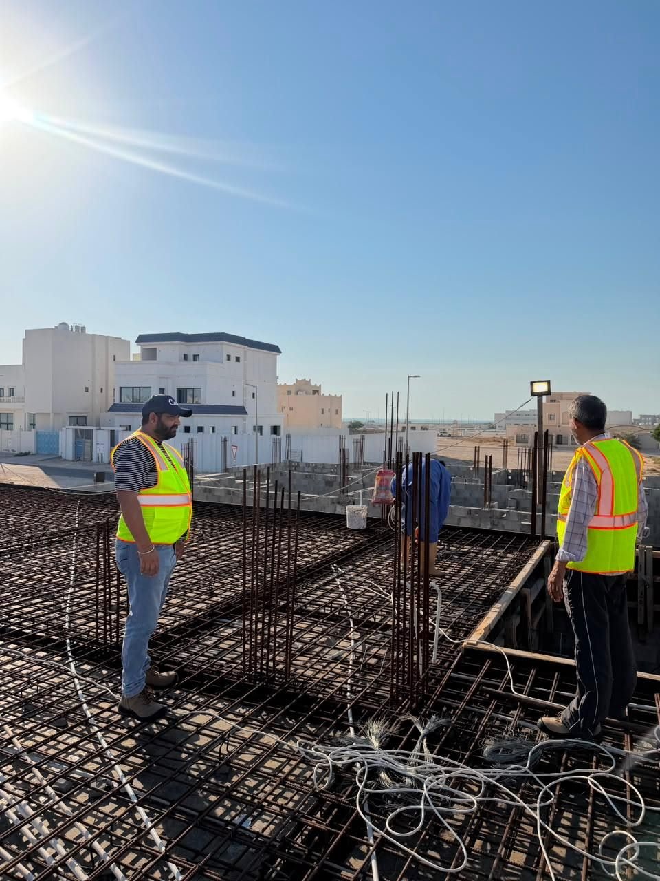 Fareeq Al Suroor site supervisors reviewing rebar work at a Doha construction site