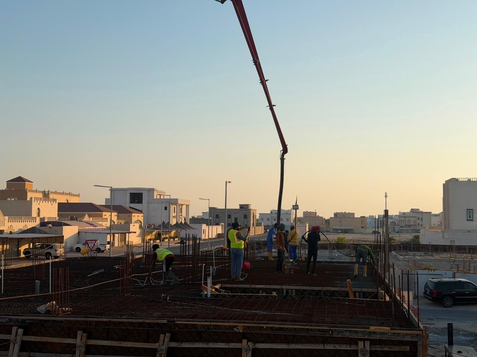 Fareeq Al Suroor building construction site with concrete pump boom, Doha
