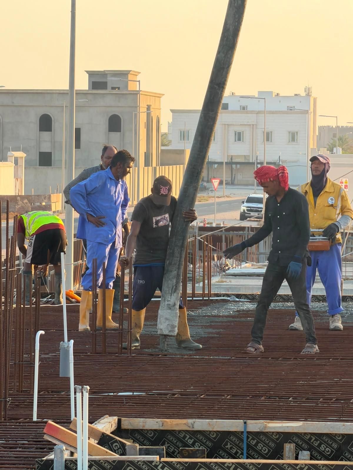 Fareeq Al Suroor site team on a rebar mat at an active infrastructure site