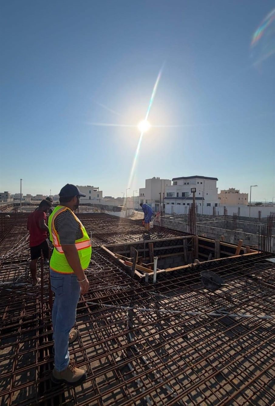 Site supervisor overseeing rebar mat installation