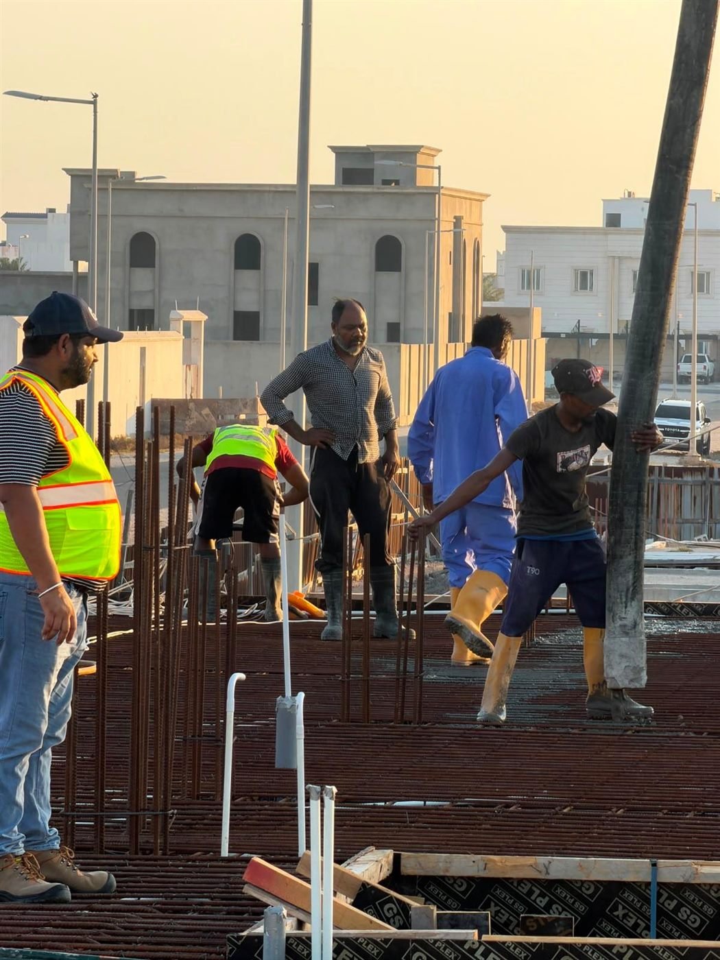 Fareeq Al Suroor crew on site during a concrete pour, golden hour